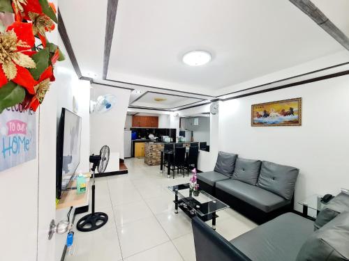 a living room with a couch and a tv at Furnished House in Calapan City Subdivision near ROBINSONS Mall L33 in Calapan