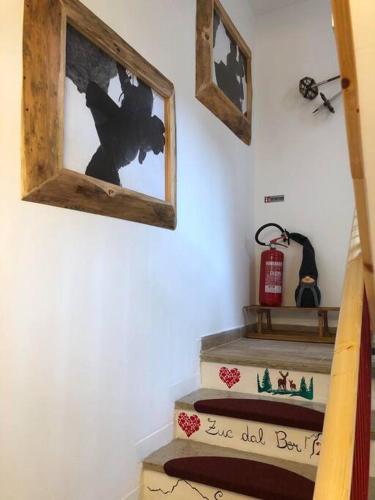 a set of stairs with a picture on the wall at Holiday Guesthouse La Casina di Butzi pet friendly - Terme di Arta - Zoncolan in Arta Terme