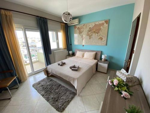 a bedroom with a bed and a blue wall at Terra Comfort Stay in Alexandroupoli