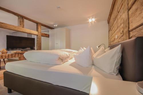 a bedroom with a large bed with white pillows at Haus Ella in Stühlingen