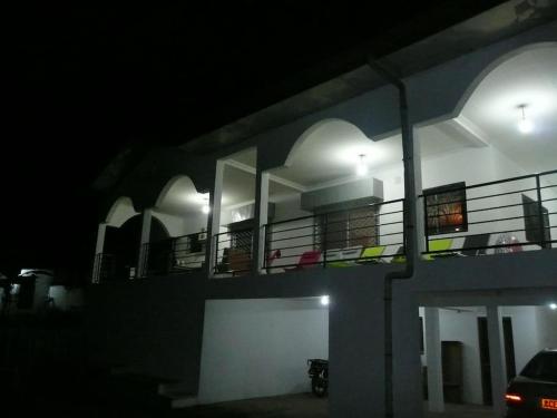 a night view of a building with balconies and lights at Villa bleue in Kribi