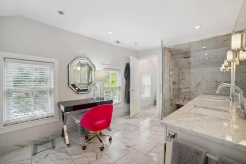 a bathroom with a desk and a red chair at Chicago Home with Hot Tub Less Than 2 Mi to Wrigley Field in Chicago