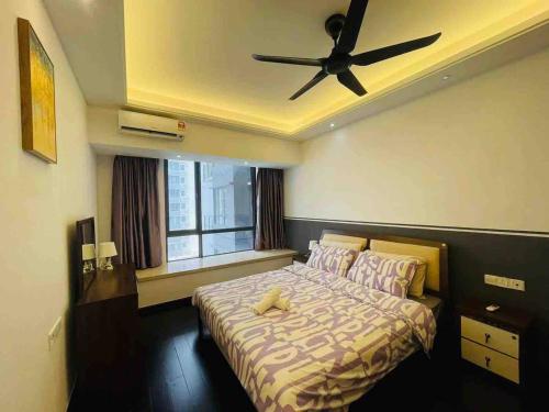 Schlafzimmer mit einem Bett und einem Deckenventilator in der Unterkunft Pleasant and Cozy 3BR Suit @ R&F Mall Johor Bahru in Johor Bahru