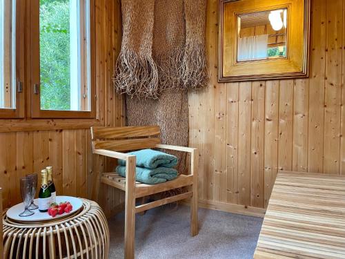 a wooden room with a chair and a table at Torppa, puusauna ja ilmastointi in Lahti