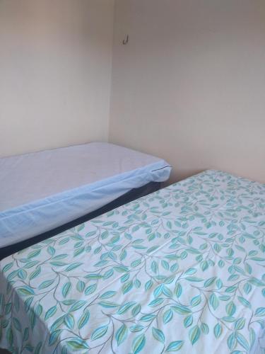um quarto com uma cama com lençóis azuis e brancos em Casa Santa Ana, Bananeiras PB em Bananeiras