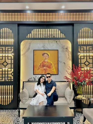 a man and a woman sitting on a couch at Thuy Duong Boutique Hotel Hue in Hue