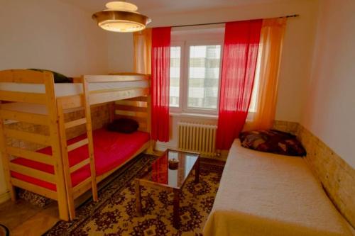 a small room with a bunk bed and a window at Retro Apartment Praha in Prague