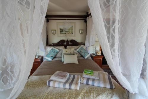 a bedroom with a bed with two towels on it at Melorne Farm Guest House in Camelford