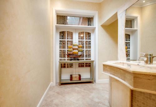 a bathroom with a sink and a window at Noel Oasis : London Retreat in London