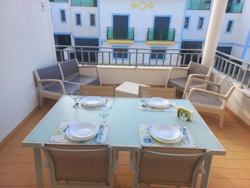 a table and chairs on the balcony of a apartment at Vila Gaio in Manta Rota