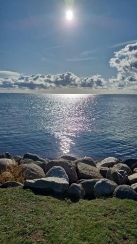 a group of rocks on the shore of a body of water at Wohnwagen auf dem Wulfenerhals ca 150m bis zum Meer in Fehmarn