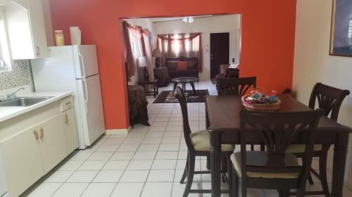 a kitchen and dining room with a table and chairs at 2 Bedroom 2 Bathroom House Centrally Located in Christiansted