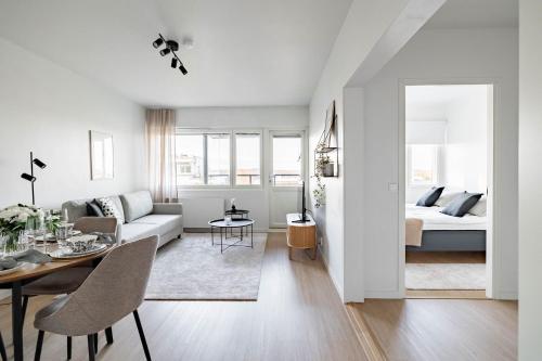a living room with a couch and a table at Nordic city apartment by R&K Apartments in Rovaniemi