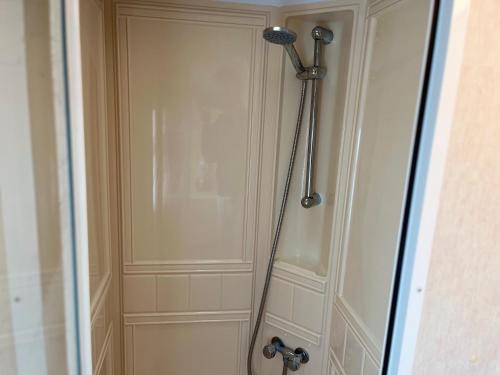 a shower stall in a bathroom with a door at Golden Sands 6 Berth Beach front Ingoldmells in Ingoldmells