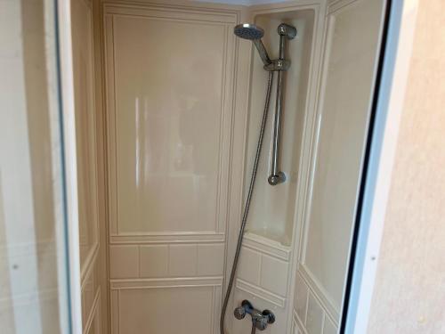 a shower stall in a bathroom with a door at Golden Sands 6 Berth Beach front Ingoldmells beds made up for arrival WIFI in Ingoldmells