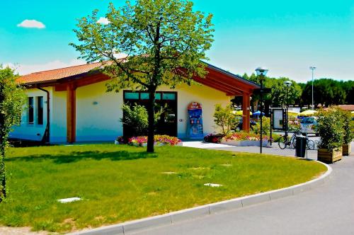 a gas station with a tree in the grass at Campeggio del Garda in Peschiera del Garda