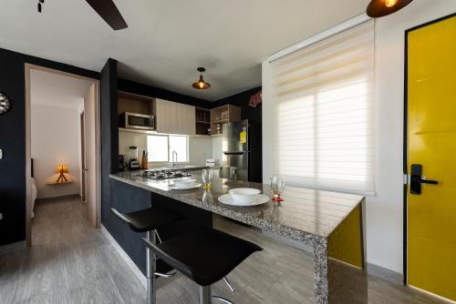 une cuisine avec un comptoir et une porte jaune dans l'établissement Nuevo apartamento en la zona norte de Cartagena, à Puerto Tierrabaja