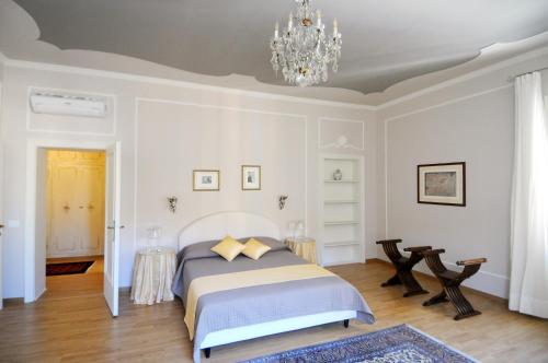 a bedroom with a bed and a chandelier at B&B Cangrande di Danese-Viviani in Verona
