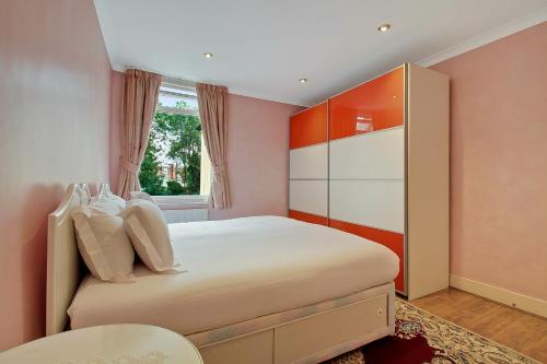 a bedroom with a large bed and a window at Noel Road in London