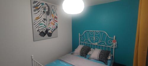 Habitación con cama y pintura en la pared en EntreLac&Océan chambre d'hôtes chez l'habitant 1, cyclotouriste bienvenue, en Aureilhan