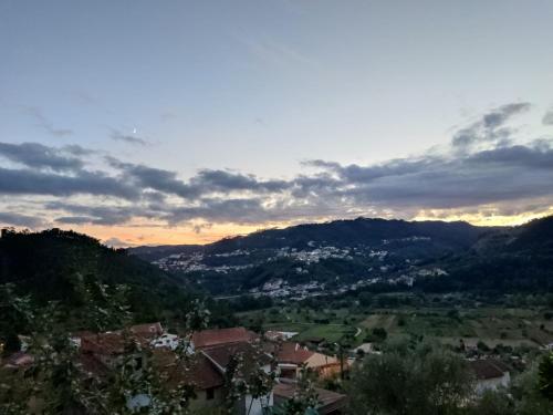 a view of a town in a valley at sunset at Casinha da Sobreira in Penacova