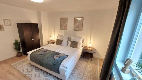 a bedroom with a bed with two towels on it at Central for 8 - 2 Apartments - 2 kitchen - 4 beds in Bochum