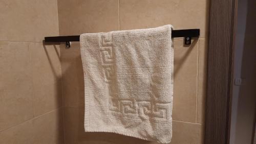 a towel hanging on a towel rack in a bathroom at Aldau heights Kevin in Hurghada