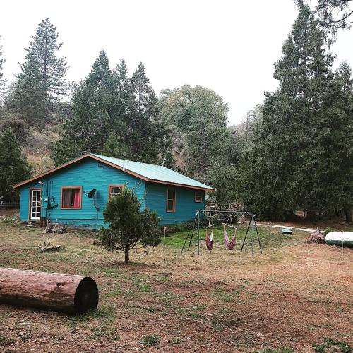 a blue house with a playground in front of it at O'Brien's Oasis in Miramonte