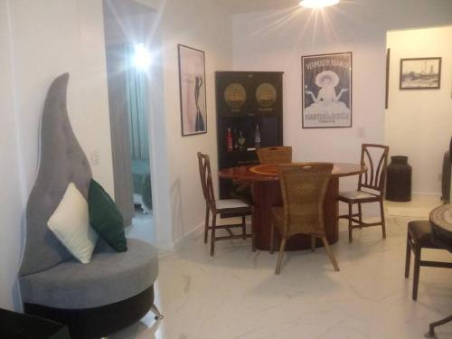 - un salon avec une chaise et une table à manger dans l'établissement Privilégio em Cabo Frio, à Cabo Frio
