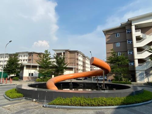 a sculpture in the middle of a courtyard with buildings at Japandi Zen: Victoria's Haven (SMDC Cheer) in Marilao