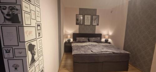 a bedroom with a bed and pictures on the wall at Katrins Ferienwohnung in Hammelburg