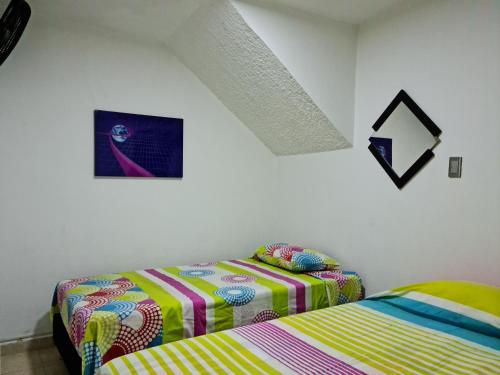 two beds sitting next to each other in a bedroom at NEW COZY APARTMENT 101 IN MEDELLIN, ENVIGADO in Envigado