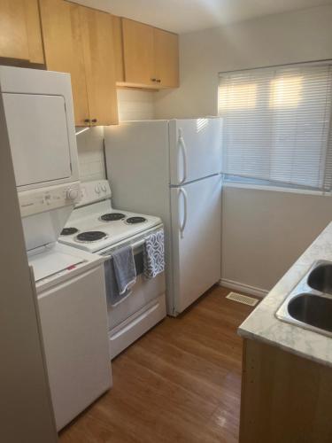 a kitchen with a stove and a refrigerator at Choose, 1of 2 entire! appart- 1BR-1sofa bed king size-free prkg- at Mohawk college city of falls in Hamilton