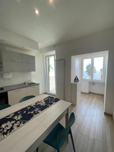 a bedroom with a bed and a kitchen with two windows at Casa A-mare in Varazze