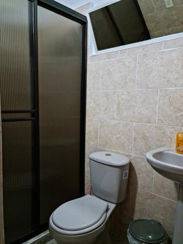 a bathroom with a toilet and a sink at NEW COZY APARTMENT 101 IN MEDELLIN, ENVIGADO in Envigado