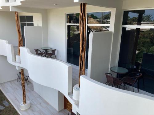 a view from the balcony of a house with white walls and windows at Apartamentos mondala in Brisas de Zicatela