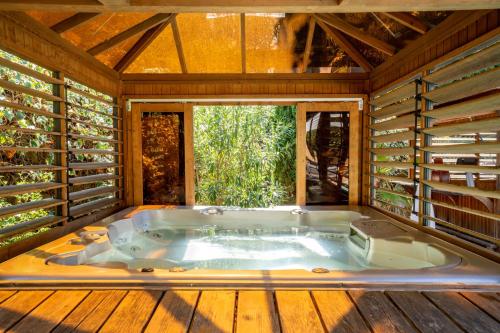 a large bath tub in a room with a window at Villa Golf les Cigales in Mouans-Sartoux