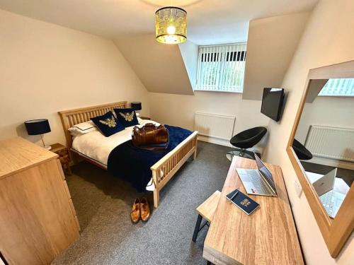a bedroom with a bed with a bag on it at Moonsticks, Modern & Well Presented 5 Bed House in Spixworth