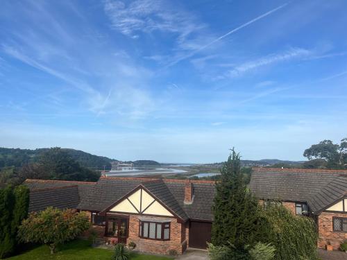 a house with a view of the water at Driftwood Lodge in Llansantffraid Glan Conwy