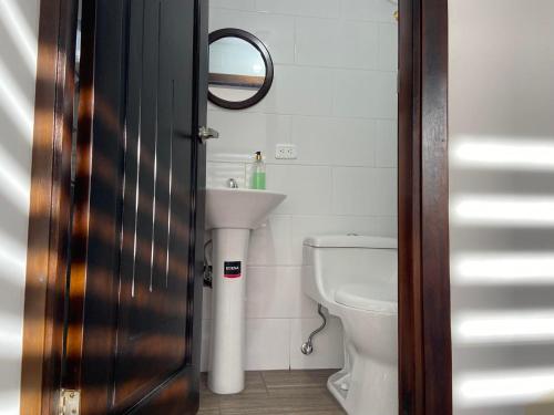 a bathroom with a toilet and a sink at La Casa del Marqués Hotel in El Chaco