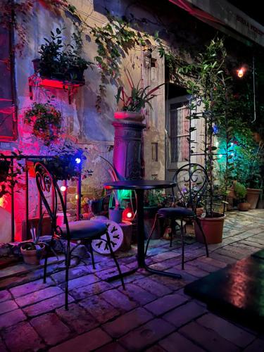 a table and chairs on a patio at night at Bed and Breakfast "Caffe-caffe" in Kikinda