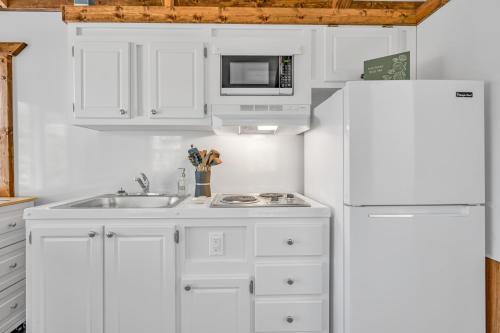 a white kitchen with a sink and a refrigerator at Yacht Haven in Marathon