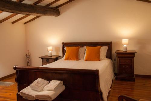 1 dormitorio con 1 cama con almohadas de color naranja y 2 lámparas en Casa do Sossego, en Igrejinha