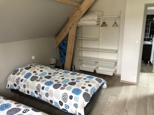 a bedroom with a bunk bed and a ladder at Gîte Damat in Asnelles