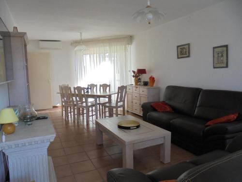 un salon avec un canapé et une table dans l'établissement RESIDENCE LES TERRASSES, à Calvi