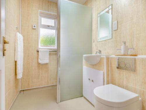 La salle de bains est pourvue de toilettes, d'un lavabo et d'un miroir. dans l'établissement Cherry Tree Corner, à Ashbourne