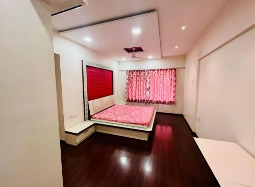 a room with a pink bed and a curtain at kolte patil 24k allura in Pune