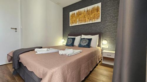a bedroom with a bed with two towels on it at Casa Mili - Ante & Marta in Jezera