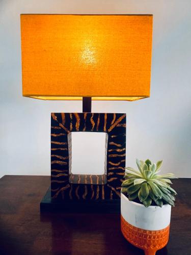 a lamp sitting on a table with a potted plant at Perfectly located City Centre apartments in Exeter