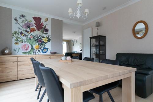 a dining room with a wooden table and chairs at Vakantiewoning Hoge Zavel in Brakel